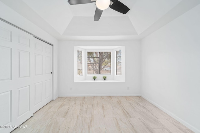 3098 S Giovanna Dr, Tucson, AZ 85730 - unfurnished bedroom with a tray ceiling, a ceiling fan, and baseboards