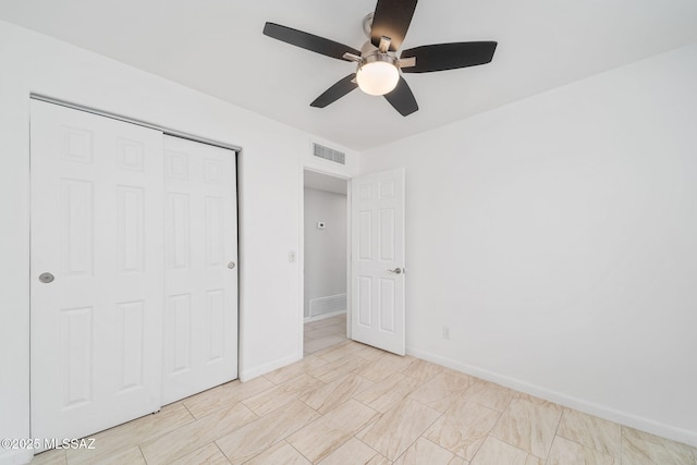 3098 S Giovanna Dr, Tucson, AZ 85730 - unfurnished bedroom with a closet, baseboards, and a ceiling fan