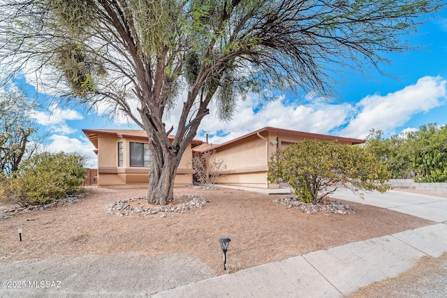 3098 S Giovanna Dr, Tucson, AZ 85730 - obstructed view of property featuring stucco siding