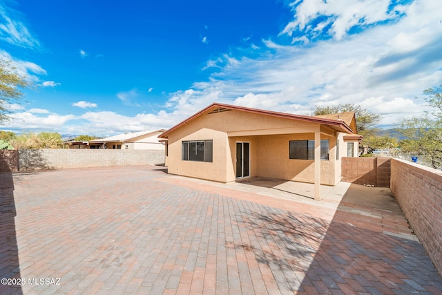 3098 S Giovanna Dr, Tucson, AZ 85730 - back of house featuring stucco siding, a fenced backyard, and a patio