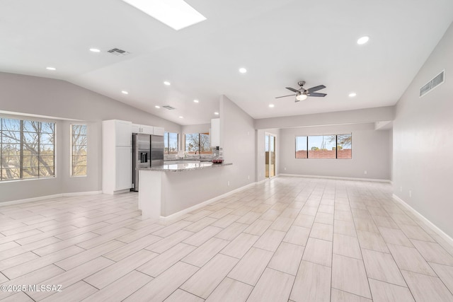 3098 S Giovanna Dr, Tucson, AZ 85730 - unfurnished living room with recessed lighting, healthy amount of natural light, lofted ceiling, ceiling fan, and baseboards