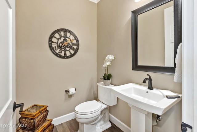 bathroom with sink, toilet, and wood-type flooring