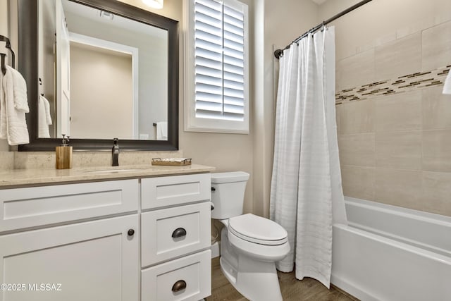 full bathroom featuring hardwood / wood-style flooring, vanity, toilet, and shower / tub combo