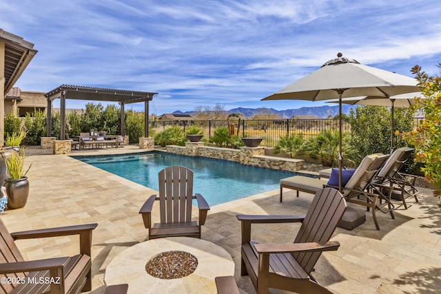 view of swimming pool with an outdoor fire pit, a patio, a pergola, and a mountain view