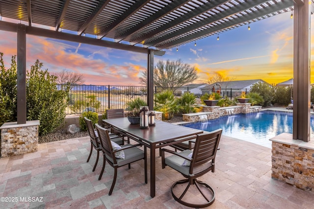 pool at dusk with a patio, a pergola, and pool water feature