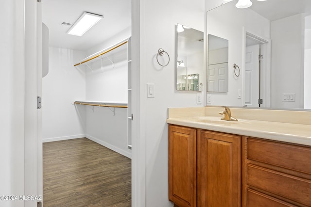 bathroom featuring hardwood / wood-style flooring and vanity