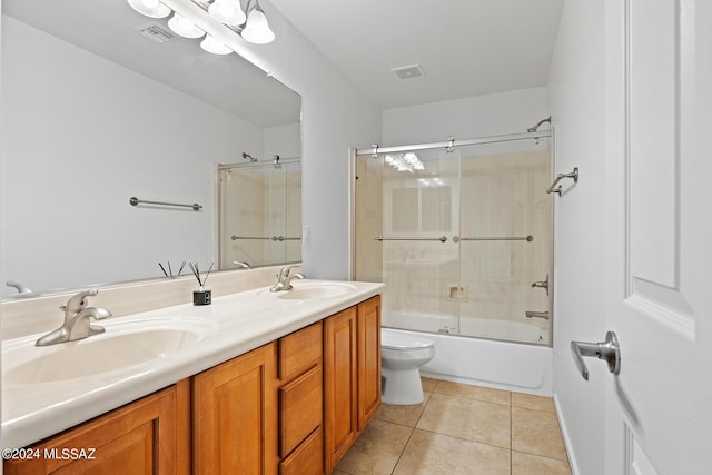 full bathroom with enclosed tub / shower combo, vanity, tile patterned floors, and toilet