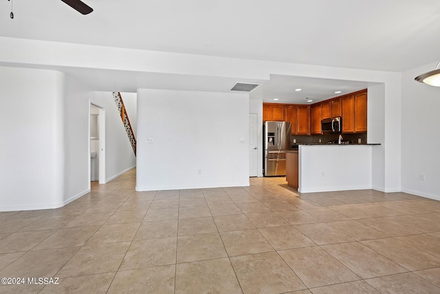 unfurnished living room with light tile patterned floors and ceiling fan