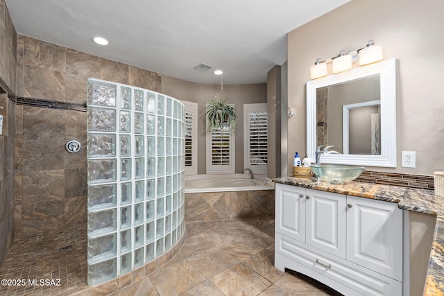 bathroom featuring vanity and shower with separate bathtub