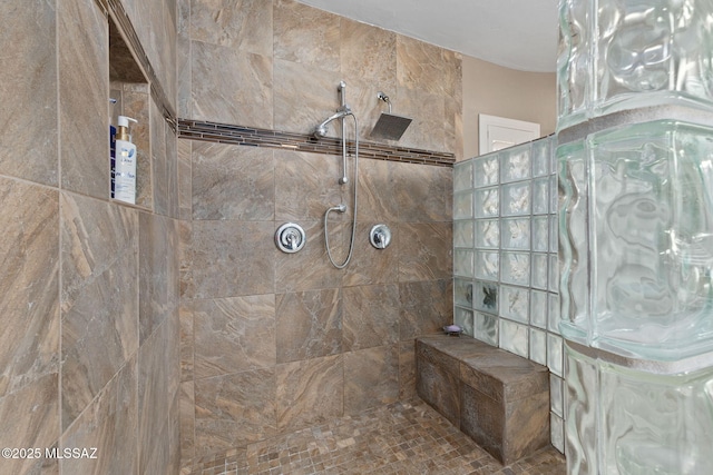 bathroom with tiled shower