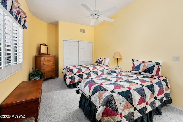 carpeted bedroom featuring vaulted ceiling, ceiling fan, and a closet