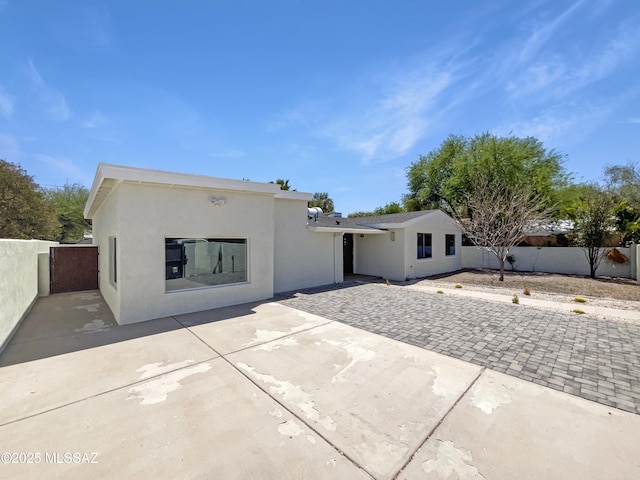 341 S Tucson Blvd, Tucson, AZ 85716 - rear view of house with stucco siding, fence, and a patio
