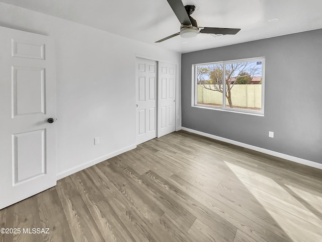 341 S Tucson Blvd, Tucson, AZ 85716 - unfurnished bedroom featuring wood finished floors, a closet, baseboards, and ceiling fan
