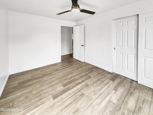 341 S Tucson Blvd, Tucson, AZ 85716 - unfurnished bedroom featuring wood finished floors, baseboards, a closet, and a ceiling fan
