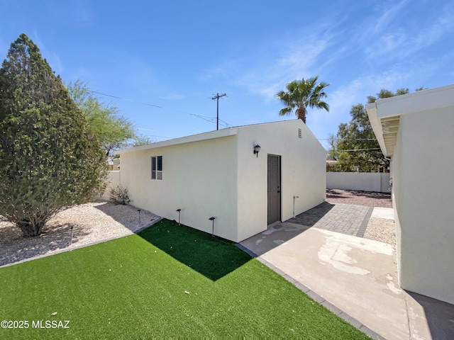 341 S Tucson Blvd, Tucson, AZ 85716 - back of property with a lawn, fence, a patio, and stucco siding