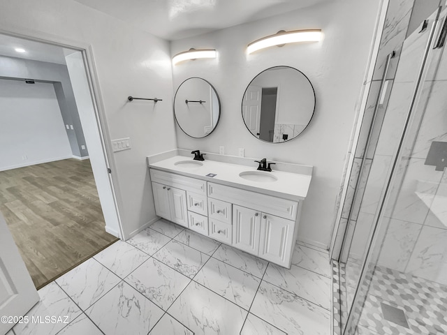 341 S Tucson Blvd, Tucson, AZ 85716 - bathroom featuring marble finish floor, double vanity, a marble finish shower, a sink, and baseboards