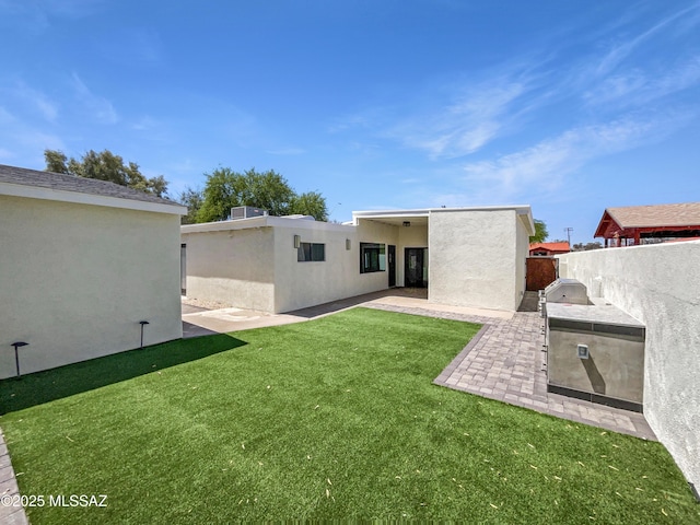 341 S Tucson Blvd, Tucson, AZ 85716 - rear view of property featuring exterior kitchen, fence, a yard, a patio, and stucco siding