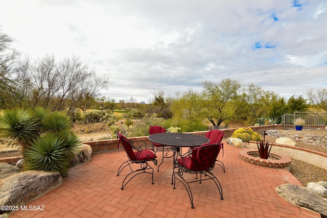 view of patio / terrace with outdoor dining area and fence