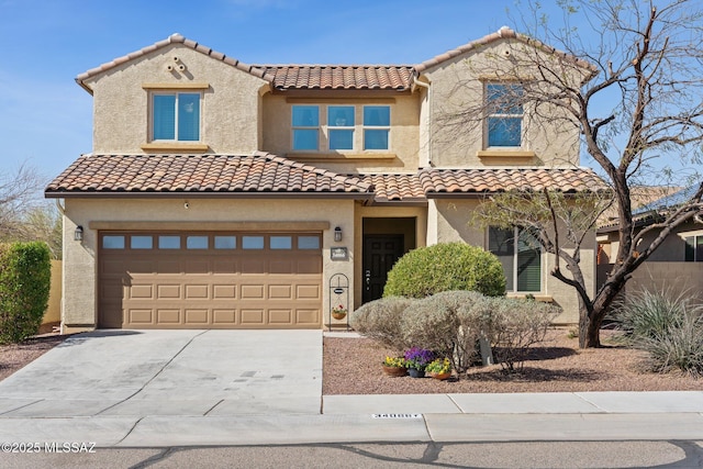 mediterranean / spanish-style house featuring stucco siding, a garage, concrete driveway, and a tiled roof