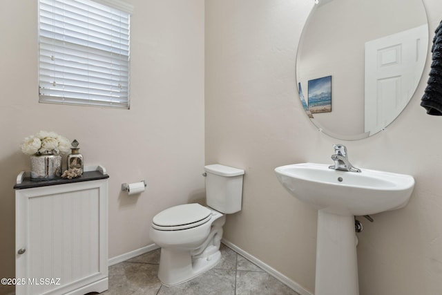 bathroom featuring tile patterned floors, toilet, and baseboards