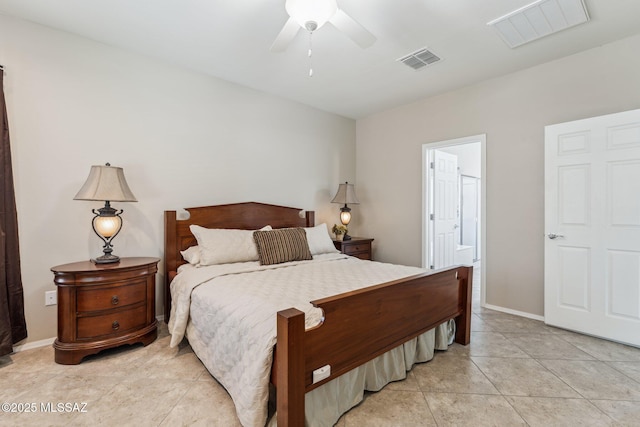 bedroom featuring light tile patterned floors, visible vents, baseboards, and ensuite bathroom