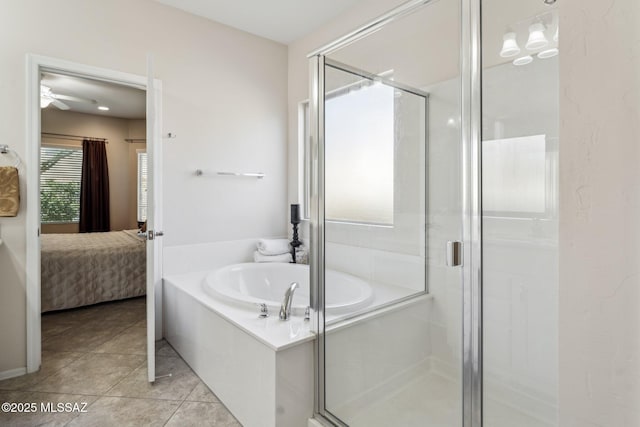 bathroom featuring a bath, tile patterned flooring, a shower stall, and ensuite bath