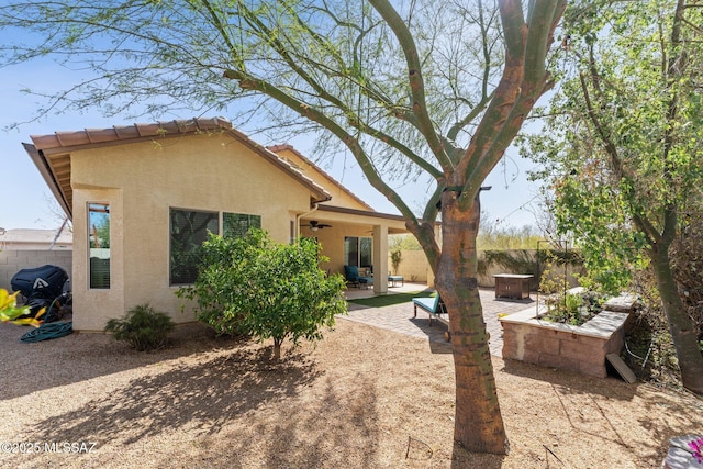 back of property featuring a patio, fence, ceiling fan, stucco siding, and a tile roof