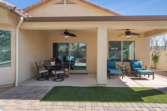 view of patio / terrace featuring outdoor dining area, a ceiling fan, and fence