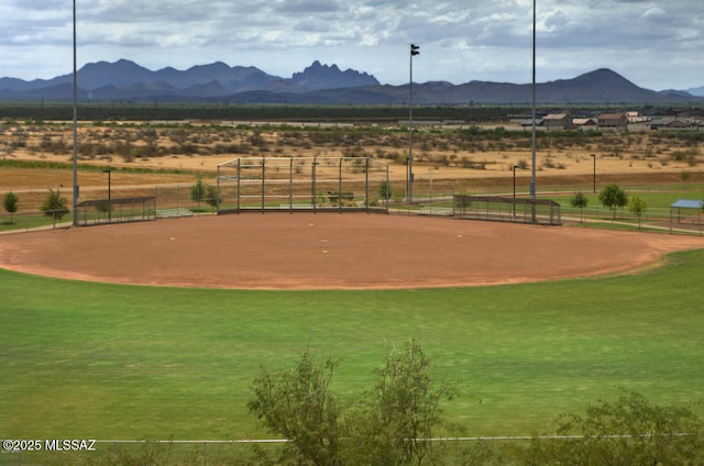 view of home's community with a mountain view, a rural view, and fence