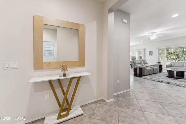 hall with tile patterned floors, recessed lighting, and baseboards