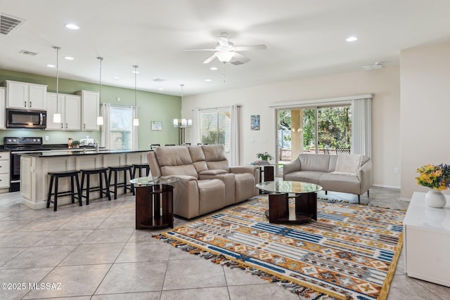 living room featuring a wealth of natural light, visible vents, and recessed lighting