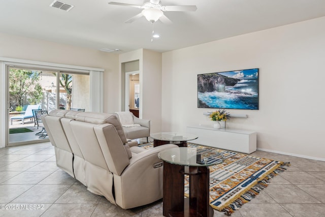 living room featuring light tile patterned flooring, visible vents, baseboards, and ceiling fan