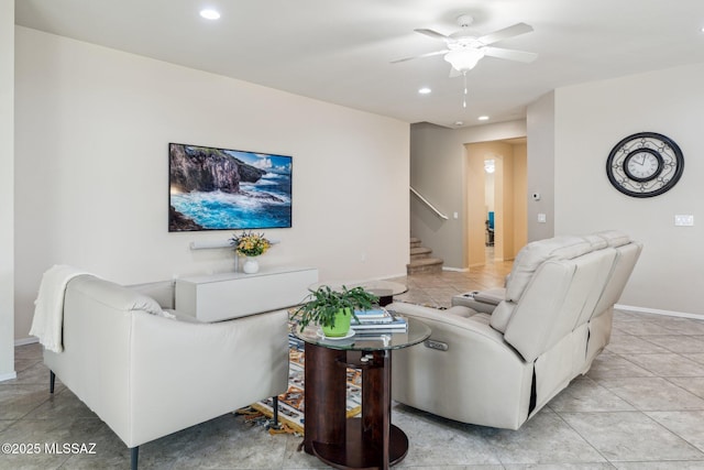 living area with light tile patterned floors, baseboards, recessed lighting, ceiling fan, and stairs