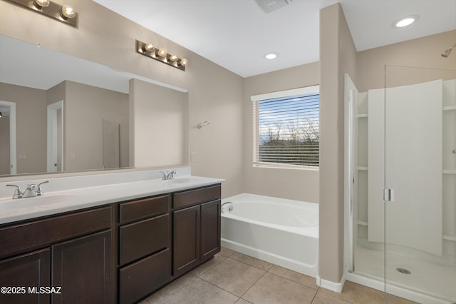 bathroom featuring tile patterned floors, plus walk in shower, and vanity