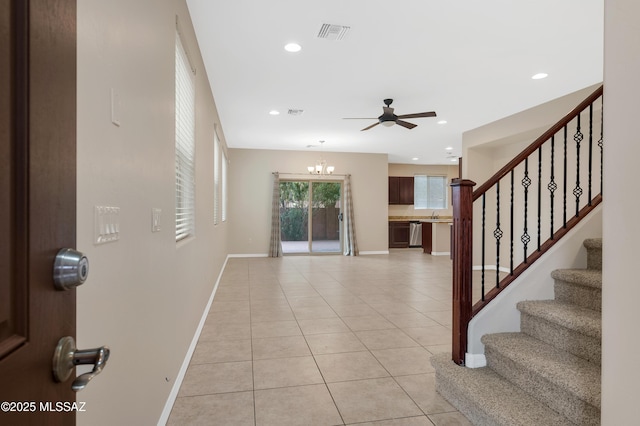 entryway featuring sink, ceiling fan with notable chandelier, and light tile patterned floors