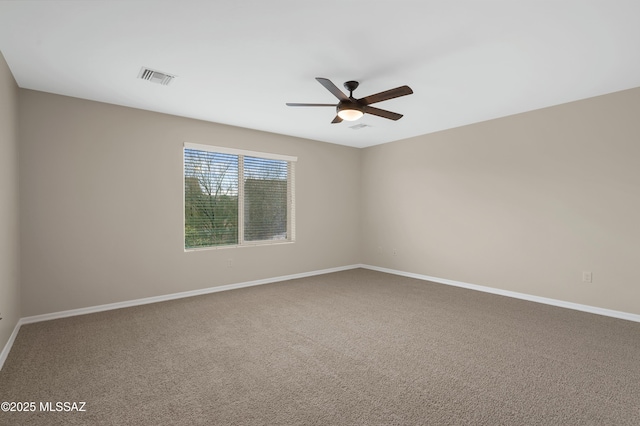 empty room with ceiling fan and carpet floors