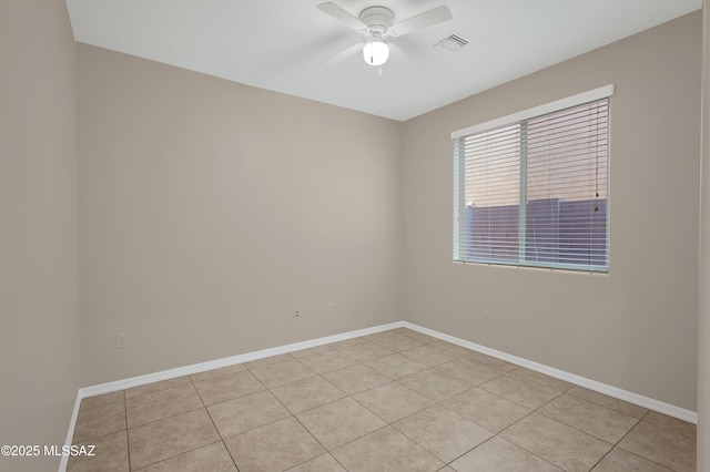 tiled spare room featuring ceiling fan