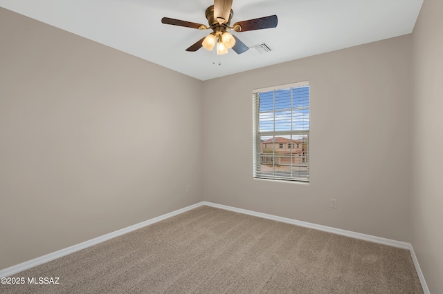 unfurnished room with ceiling fan and carpet