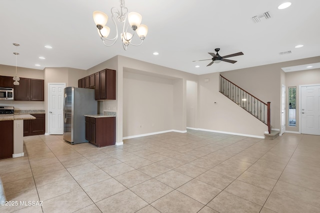 unfurnished living room with ceiling fan with notable chandelier and light tile patterned floors