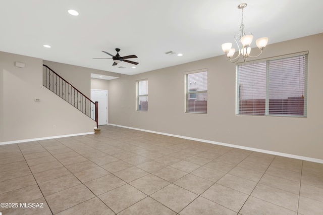 empty room featuring ceiling fan with notable chandelier