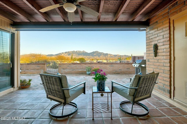 view of patio featuring visible vents, area for grilling, fence, and a mountain view