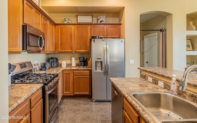 13289 E Wranglers Rest Dr, Vail, AZ 85641 - kitchen featuring appliances with stainless steel finishes, a sink, brown cabinets, and light stone counters