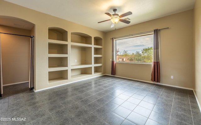 13289 E Wranglers Rest Dr, Vail, AZ 85641 - unfurnished room with built in shelves, ceiling fan, and baseboards