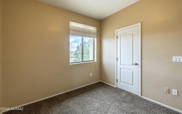13289 E Wranglers Rest Dr, Vail, AZ 85641 - unfurnished bedroom with dark carpet and baseboards