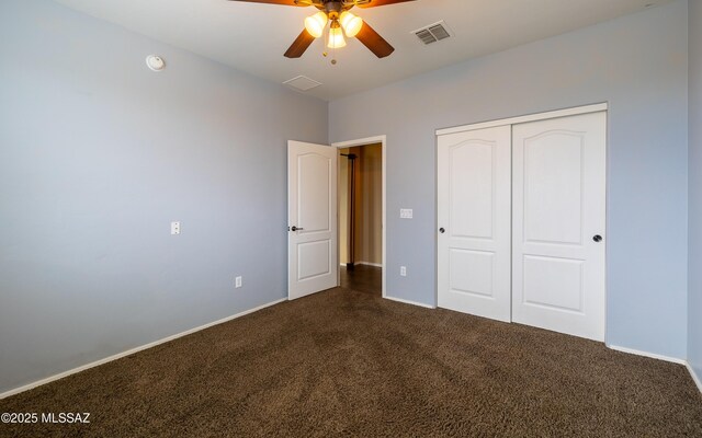 13289 E Wranglers Rest Dr, Vail, AZ 85641 - unfurnished bedroom with dark carpet, a closet, baseboards, and a ceiling fan