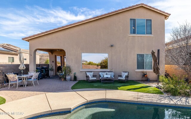 13289 E Wranglers Rest Dr, Vail, AZ 85641 - rear view of house featuring stucco siding, an outdoor living space, a patio area, fence, and an outdoor pool