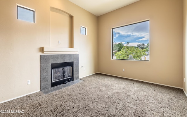 13289 E Wranglers Rest Dr, Vail, AZ 85641 - unfurnished living room featuring carpet floors, a tile fireplace, and plenty of natural light