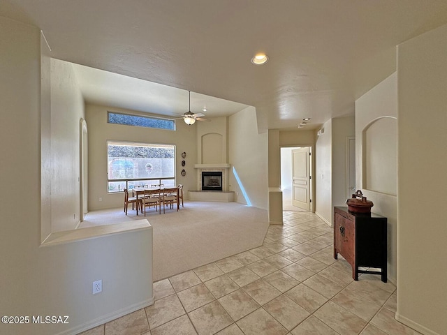 interior space with light colored carpet and ceiling fan