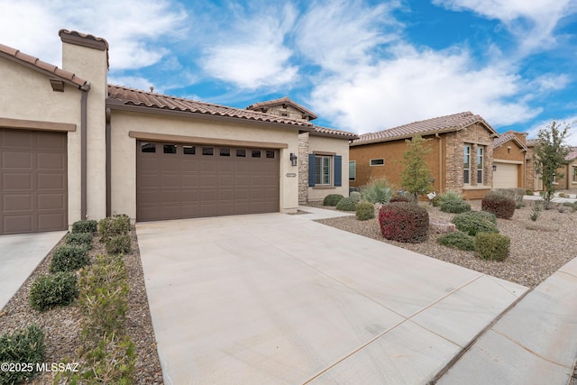 mediterranean / spanish-style home featuring an attached garage, stucco siding, driveway, and a tiled roof