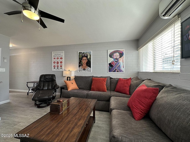 living room with ceiling fan, wood-type flooring, a wall mounted AC, and brick wall